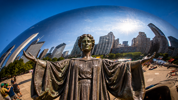 Alma Mater statue with Chicago skyline behind