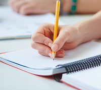 person writing with pencil