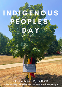 A tree planted on the UIUC campus with an illegible plaque placed in front.