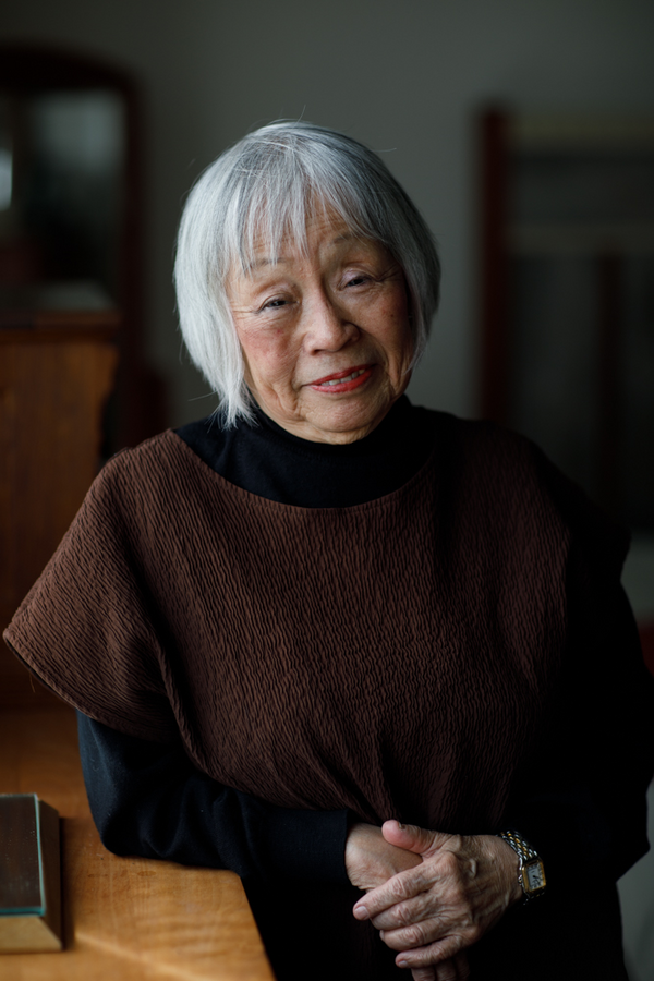 A photograph of a woman smiling as she faces the camera.
