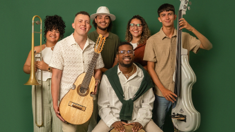 Six members of Cultura Pesá pose together against a green background, holding a cuatro, trombone, double bass, and percussion instrument. The group’s name, “Cultura Pesá,” appears at the bottom.