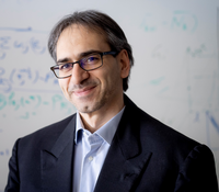 Professor Gesualdo Scutari, smiling, wearing black glasses and a blazer