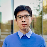Professor Yunzong Xu, wearing glasses and a blue sweater