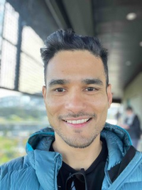 Dr. Spandan Mishra, wearing a blue coat and smiling