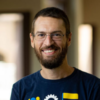 Professor Albert Berahas, wearing glasses and smiling