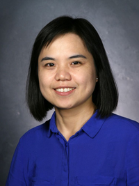 Professor X. Jessie Yang, wearing a blue shirt and smiling