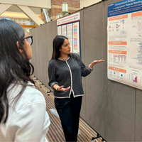 Student talking about a poster at a conference.