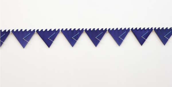 Image of Every Ocean Hughes' "Beyond the Will to Measure"; there can be seen wall-mounted ceramic clocks with wave movements.