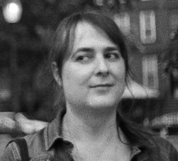 A black and white image of Allison Parish glancing to the side.