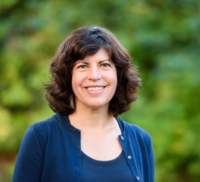 Guest Speaker Dawn O'Dell smiling straight ahead at camera wearing a blue cardigan sweater with a blue top.