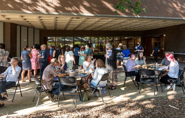 Group of people gathering on the Levis patio