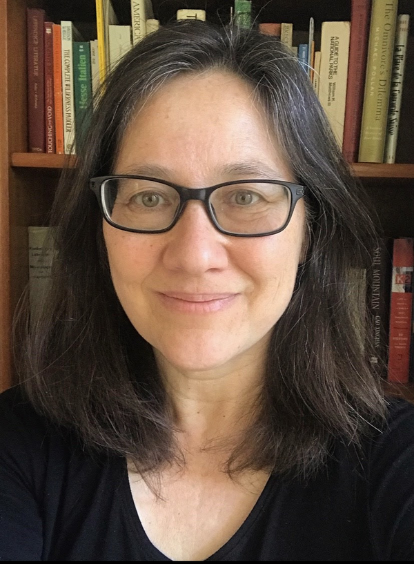 Leti Volpp in front of book case