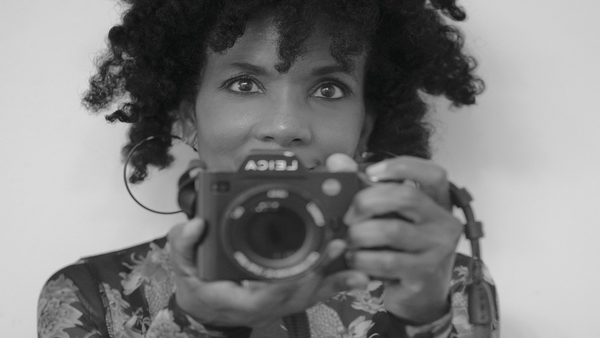 Shelia Pree Bright taking a picture of herself in the mirror with a camera