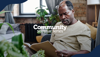 Community Seminar Series. A man sitting in a chair and reading a book.