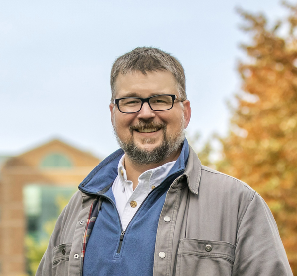 A headshot of Dr. Thomas Benson