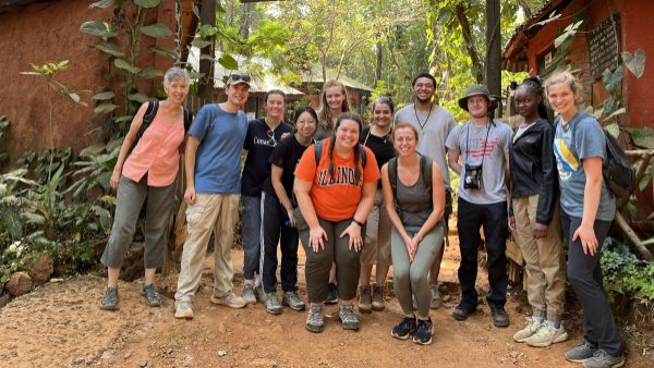 Group of students gathered in front of sign that reads "Tacugama Chimps Welcome You"