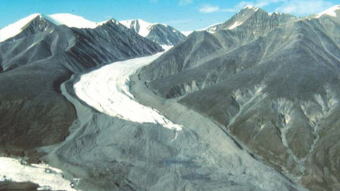 Glacier flowing between two mountains