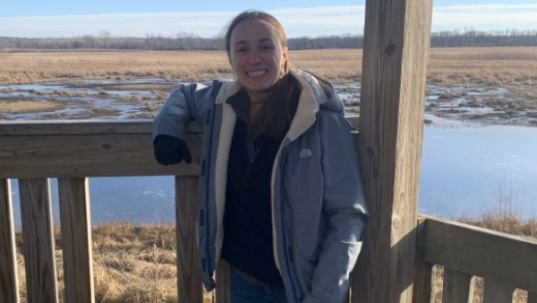 Seminar speaker standing by wetland