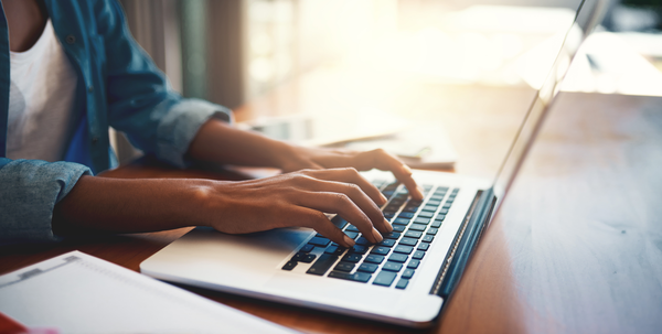 person typing on laptop computer