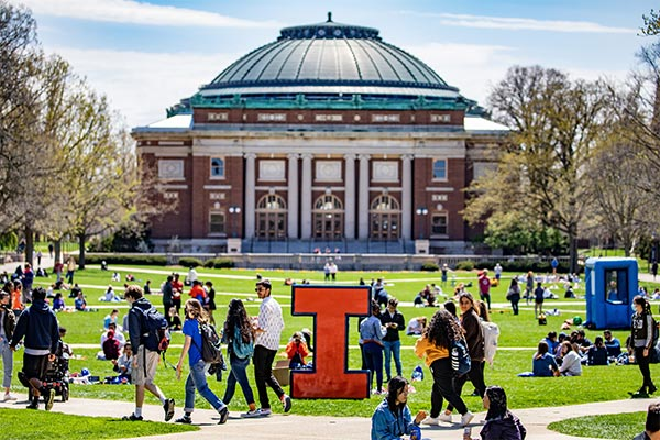 U of I students enjoy a spring day on the main quad. A large Block I is set up in front of Foellinger for photos.