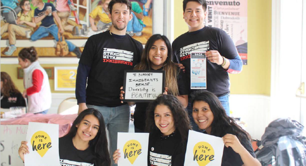 Students hold posters and wear shirts promoting DACA and Undocumented student allies.