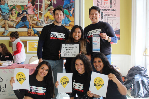 Students hold posters and wear shirts supporting DACA and Undocumented students.