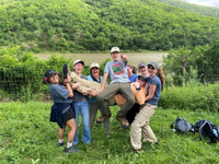 Students in South Africa holding each other up and smiling