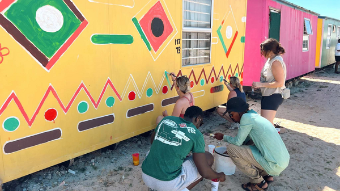 Students painting a shed in South Africa