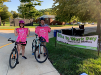 people on bikes holding up a t-shirt
