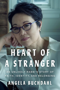 Book cover of Heart of a Stranger by Angela Buchdahl, featuring Angela seated with one arm resting on a table and wearing a necklace with a Star of David. The subtitle reads: “An Unlikely Rabbi’s Story of Faith, Identity, and Belonging.”