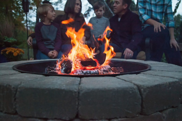 A small fire surrounded by paver stones