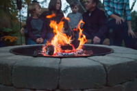 A small fire surrounded by paver stones