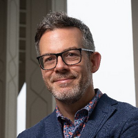 Picture of Chris Blattman, who has short hair and wears glasses