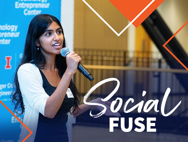 Photo of female student pitching her startup idea, speaking into a handheld microphone