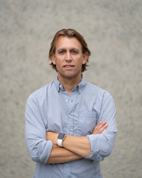 Man with Blue shirt and blonde medium length hair.