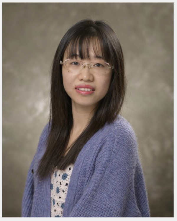 Female with dark hair and glasses