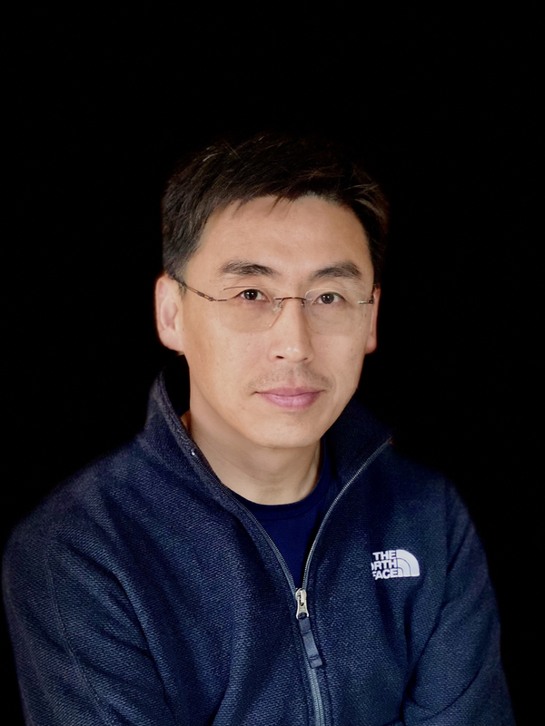 Person with dark hair and glasses.