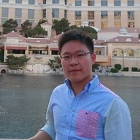 Lawrence Wang - Person with short dark hair and classes with blue shirt.