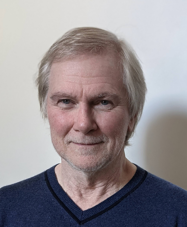 Photo of Dr. Frank McCormick. He has short, blonde hair and is wearing dark blue, v-neck shirt.