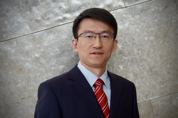 Dr. Ji Zhang - person with glasses and dark hair.